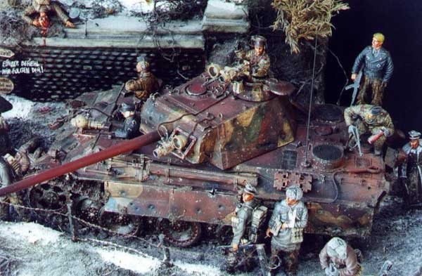 A bird's eye view (or Jabos as the case may be) of the Panther Ausf. G. Note the numerous shell hits of various caliber to the side skirts, including one penetration. The long scrape on the most forward skirt was accomplished by scoring the Aber Brass and slightly bending it over. The gun cleaning tube was heavily weathered by slicing out portions of the Tamiya part and then after painting, mixing in ground up pastels and Tamiya "X-20A Acrylic Paint Thinner" brushed on with a 5/0 spotter brush.