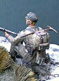 Wearing a Hornet Mountain Troops head (minus the Edelweiss) this Dragon figurine sweeps the area with a MG-34. The rucksack and ice pick is typical of the Gebirgsjagers. This stray Grenadier was collected during the retreat and amalgamated into the kampfgruppe. Note the scrapes in his mess tin done by thinning Testors steels and brushing on with a 00 spotter brush. The Hornet head has an excellent set of goggles molded on which were touched with two-part resin to simulate glass