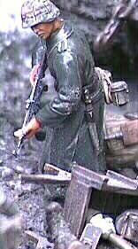 A Grenadier in a rubberized rainment checks the Russian dead. He wears an Oak Leaf "A" second model helmet cover. Note the scrapes on his knife frog and mess tin.