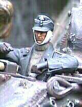 Tight shot of the Panther's driver. This Sturmmann is an amalgamation of a Verlinden torso and left arm with a Jaguar wounded head and right arm. Note the grommet just below his left hand where the IR cable is coupled