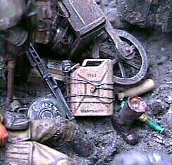 Close up of the gear spilled from the Russian's wheel burrow include this Italeri jerrycan and Tamiya stick grenade tied on with brass wire. Note beside the jerrycan is a blown off Russian boot with a femur protruding from it