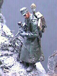 This Dragon Grenadier with a Hornet head wears a rubberized rainment (aka motorcyclist coat). He carries an extra Verlinden photo-etch belt with a StG 44 ammo pouch and a panzerfaust. Not the splattered mud on his boots and rainment. The sheen of these rubberized coats was achieved with Testor's semi-glosscote