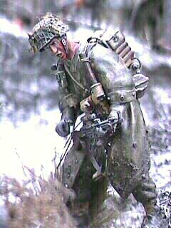 This Dragon Obergrenadier  in a splinter pattern zeltbahn has a MK-35 head. I added some dried flowers to his helmet meshing. The buttons on the zeltbahn were improved by stretching some sprue and then slicing off thin disks